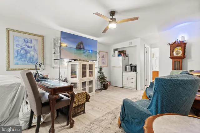 a living room with furniture and kitchen view