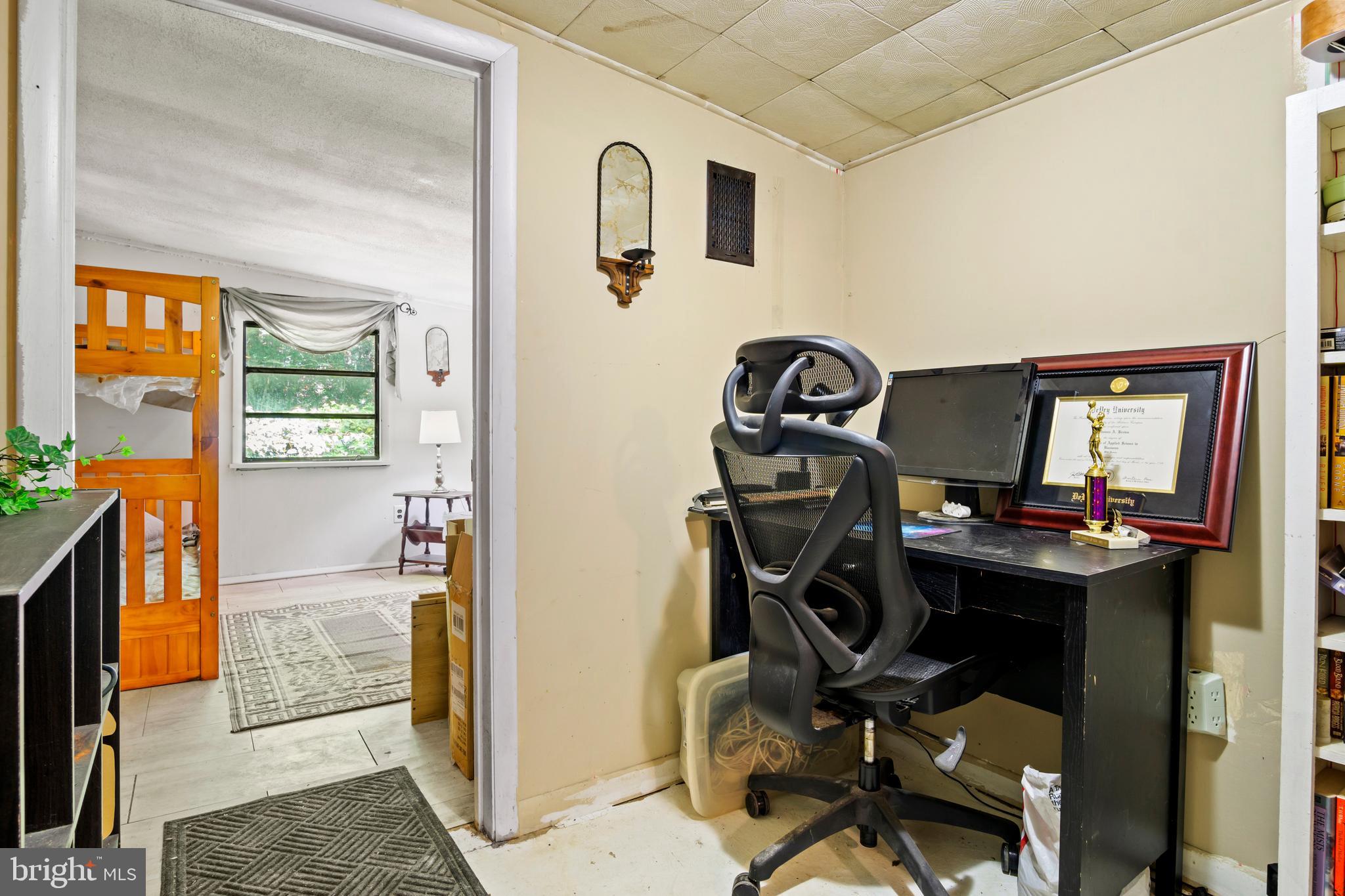 13640 Collins Pond Road East Georgetown, DE 19947 - Photo 34 of 41 a view of a workspace with furniture and a window
