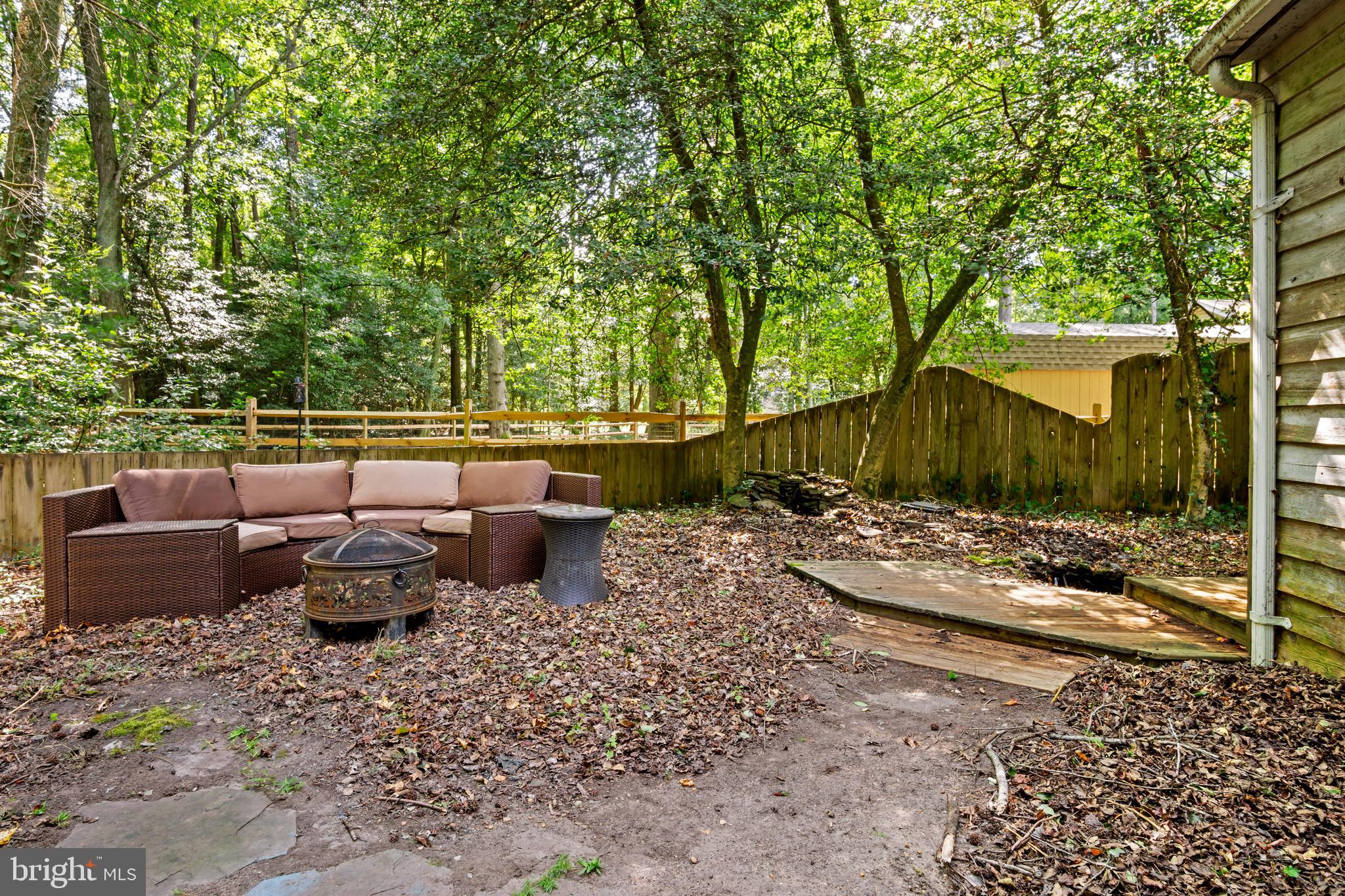 13640 Collins Pond Road East Georgetown, DE 19947 - Photo 39 of 41 a view of a backyard with lawn chairs under an umbrella