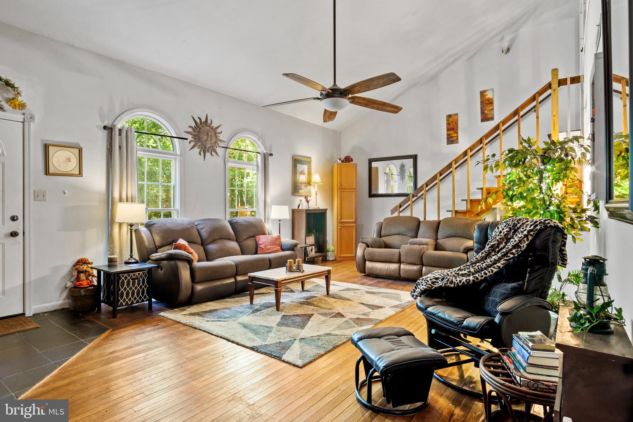 13640 Collins Pond Road East Georgetown, DE 19947 - Photo 6 of 41 a living room with furniture or couch and a chandelier