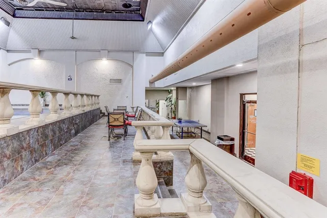 a living room with furniture and stairs