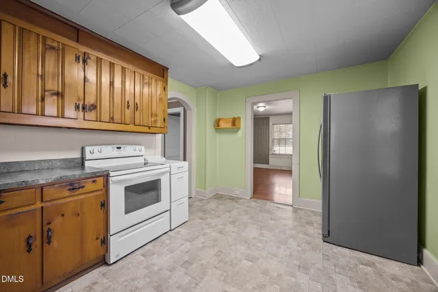 a kitchen with a stove and a refrigerator