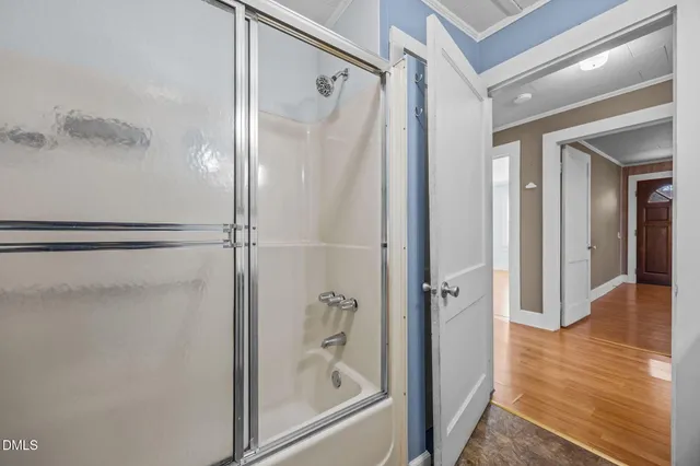 a bathroom with a glass shower door