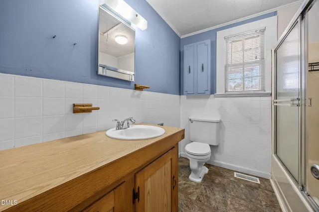 a bathroom with a sink a toilet and a mirror