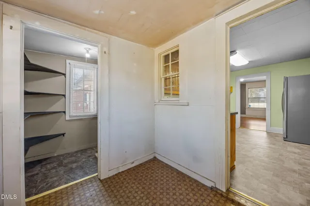 a view of livingroom with hardwood floor and a bathroom