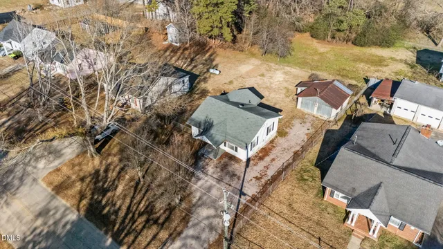 an aerial view of a house with a yard