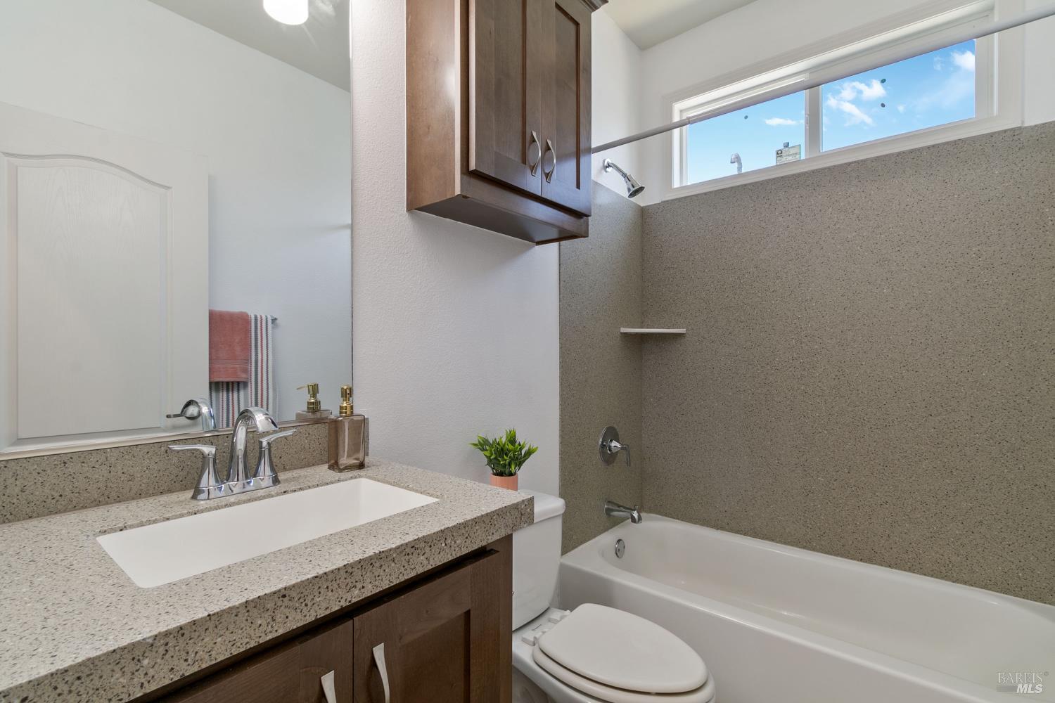 1161 Benicia Road, Unit 18 Vallejo, CA 94591 - Photo 11 of 16 a bathroom with a granite countertop sink toilet and bathtub