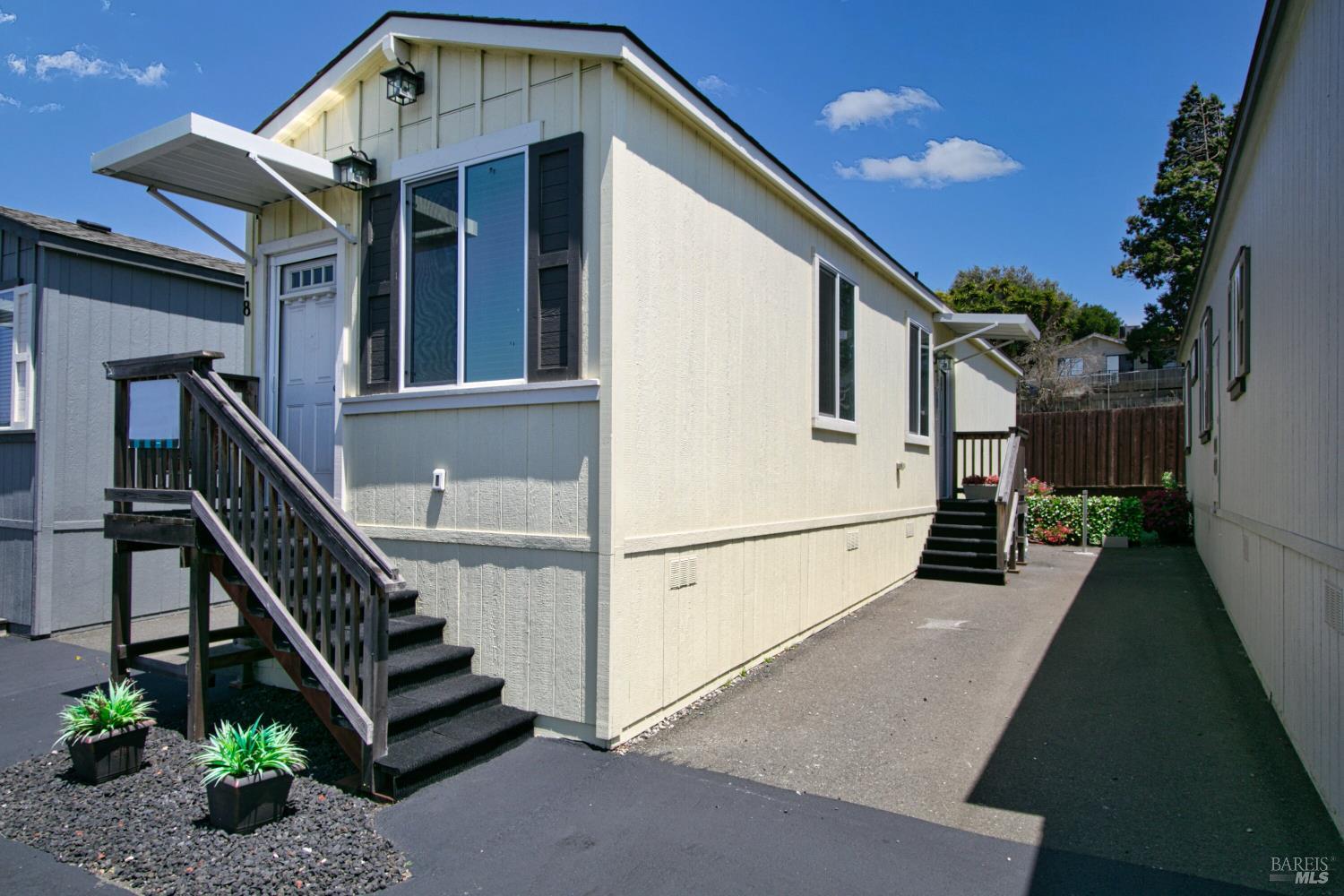 1161 Benicia Road, Unit 18 Vallejo, CA 94591 - Photo 2 of 16 a view of a house with wooden stairs and a small yard