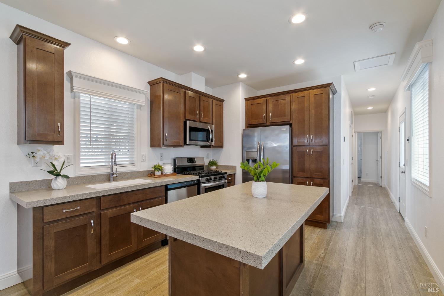 1161 Benicia Road, Unit 18 Vallejo, CA 94591 - Photo 4 of 16 a kitchen with a sink a counter top space and stainless steel appliances
