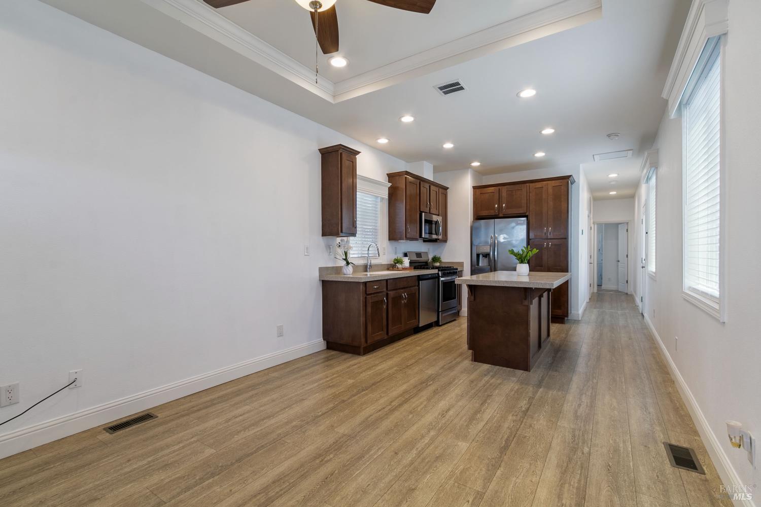 1161 Benicia Road, Unit 18 Vallejo, CA 94591 - Photo 9 of 16 a kitchen with stainless steel appliances kitchen island wooden cabinets and granite counter tops