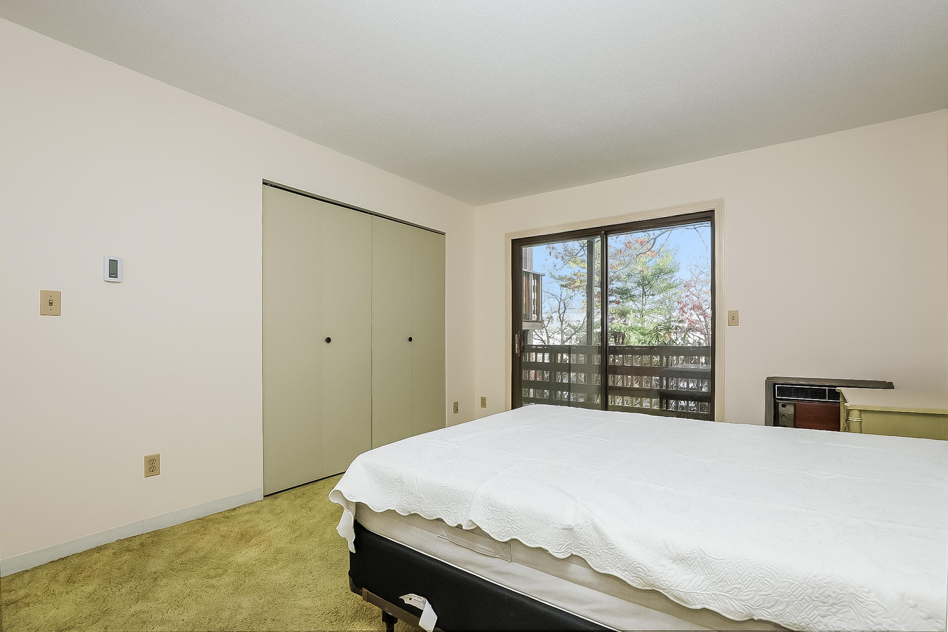 800 Bearses Way, Unit 3EB Hyannis, MA 02601 - Photo 14 of 23 a bed sitting in a bedroom next to a window