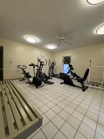 a room with gym equipment and a table