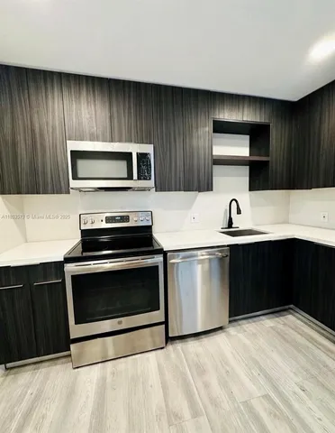 a kitchen with a stove and a microwave