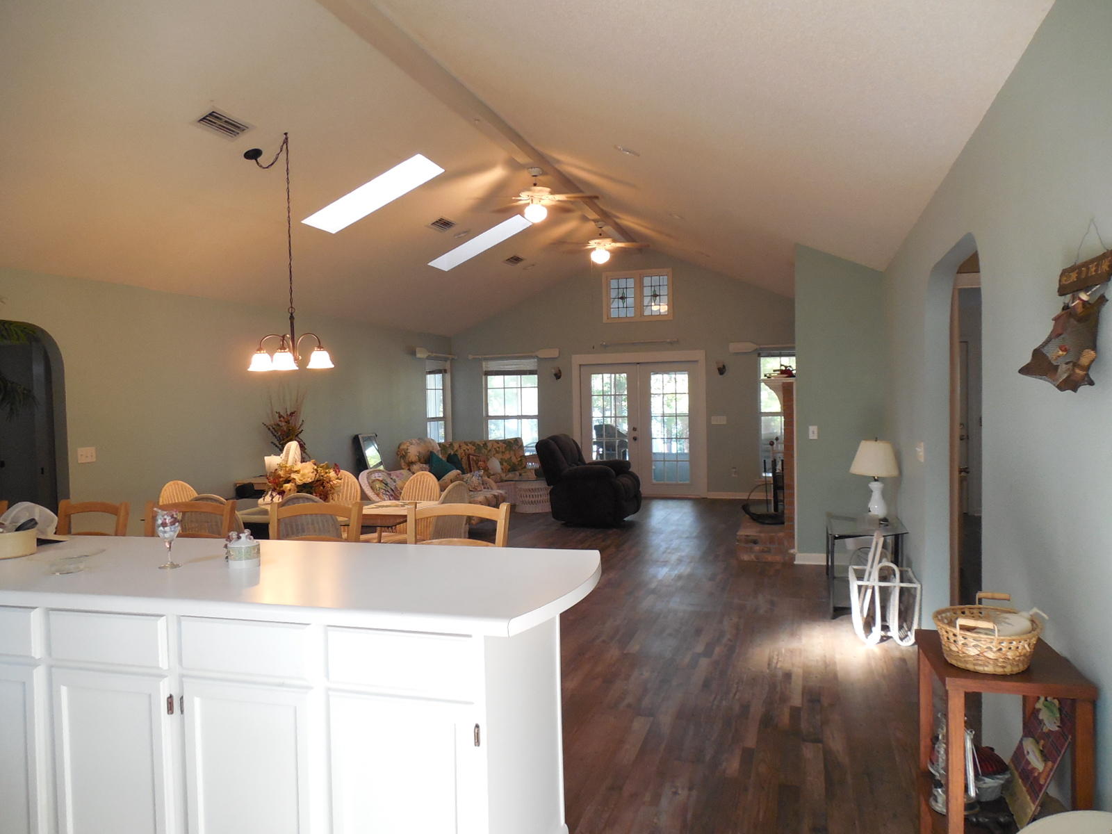 732 Spring Lake Road DeFuniak Springs, FL 32433 - Photo 13 of 44 a view of a dining room with furniture wooden floor and chandelier