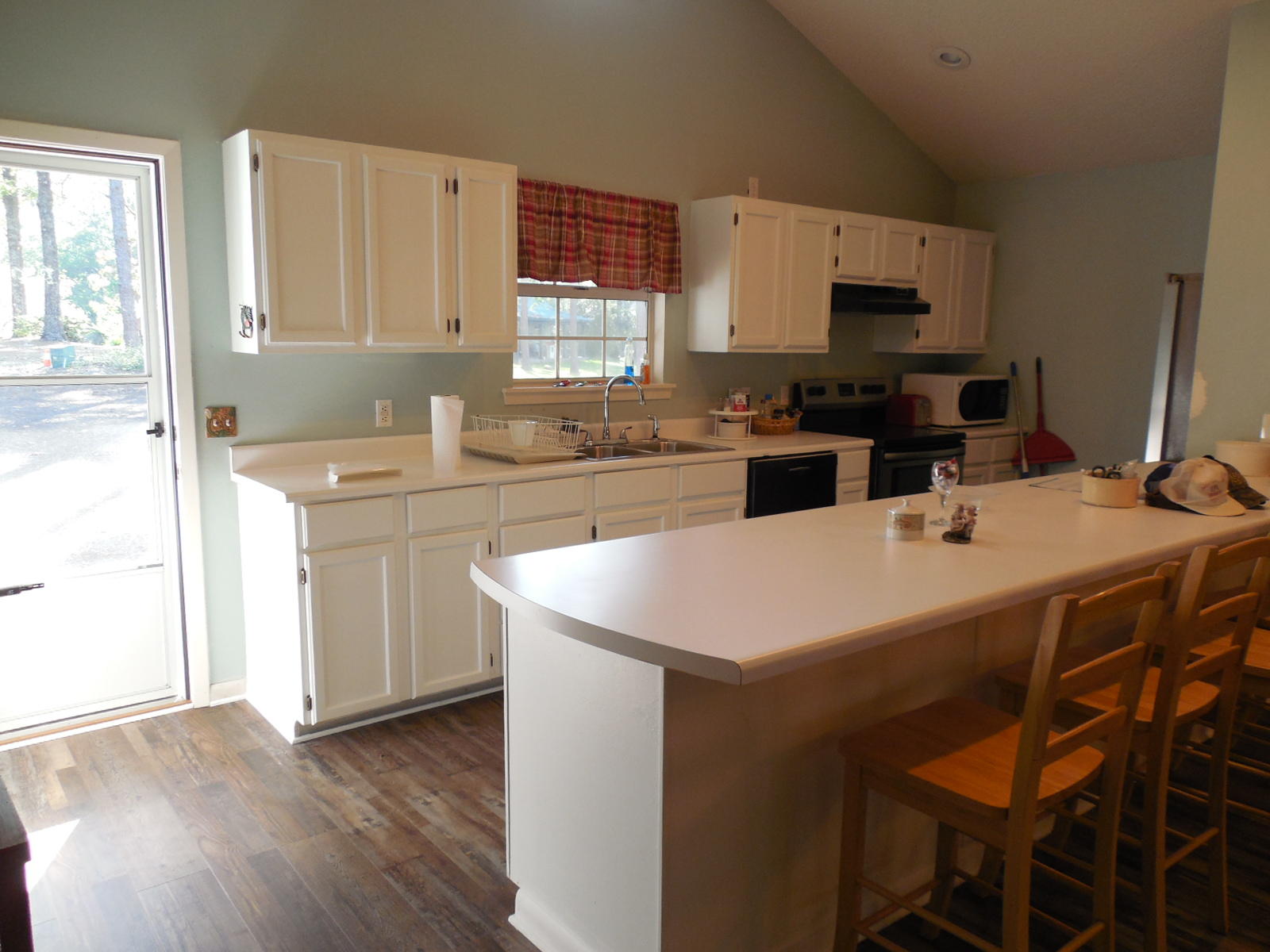732 Spring Lake Road DeFuniak Springs, FL 32433 - Photo 14 of 44 a kitchen with a sink a stove a refrigerator and cabinets