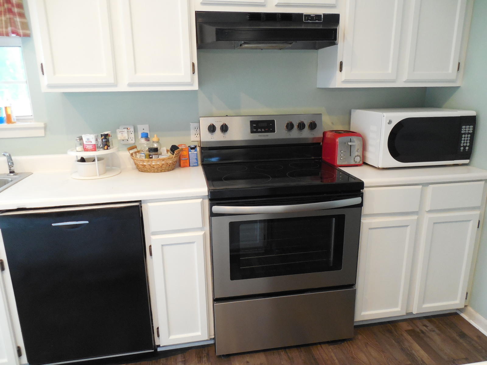 732 Spring Lake Road DeFuniak Springs, FL 32433 - Photo 17 of 44 a kitchen with stainless steel appliances granite countertop a stove a microwave and cabinets