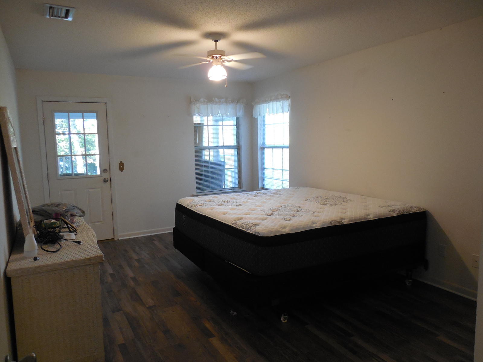 732 Spring Lake Road DeFuniak Springs, FL 32433 - Photo 25 of 44 a bedroom with a bed and a chandelier