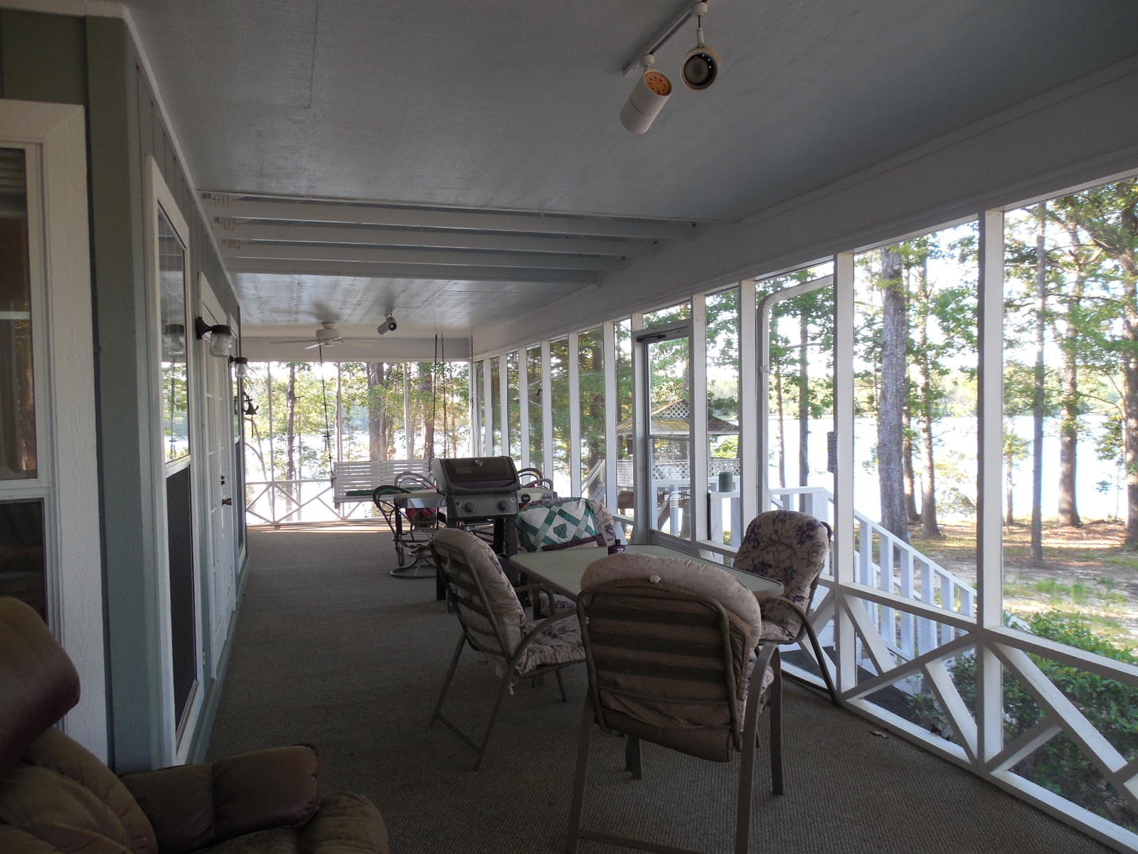 732 Spring Lake Road DeFuniak Springs, FL 32433 - Photo 27 of 44 a view of a dining room with furniture large windows and wooden floor