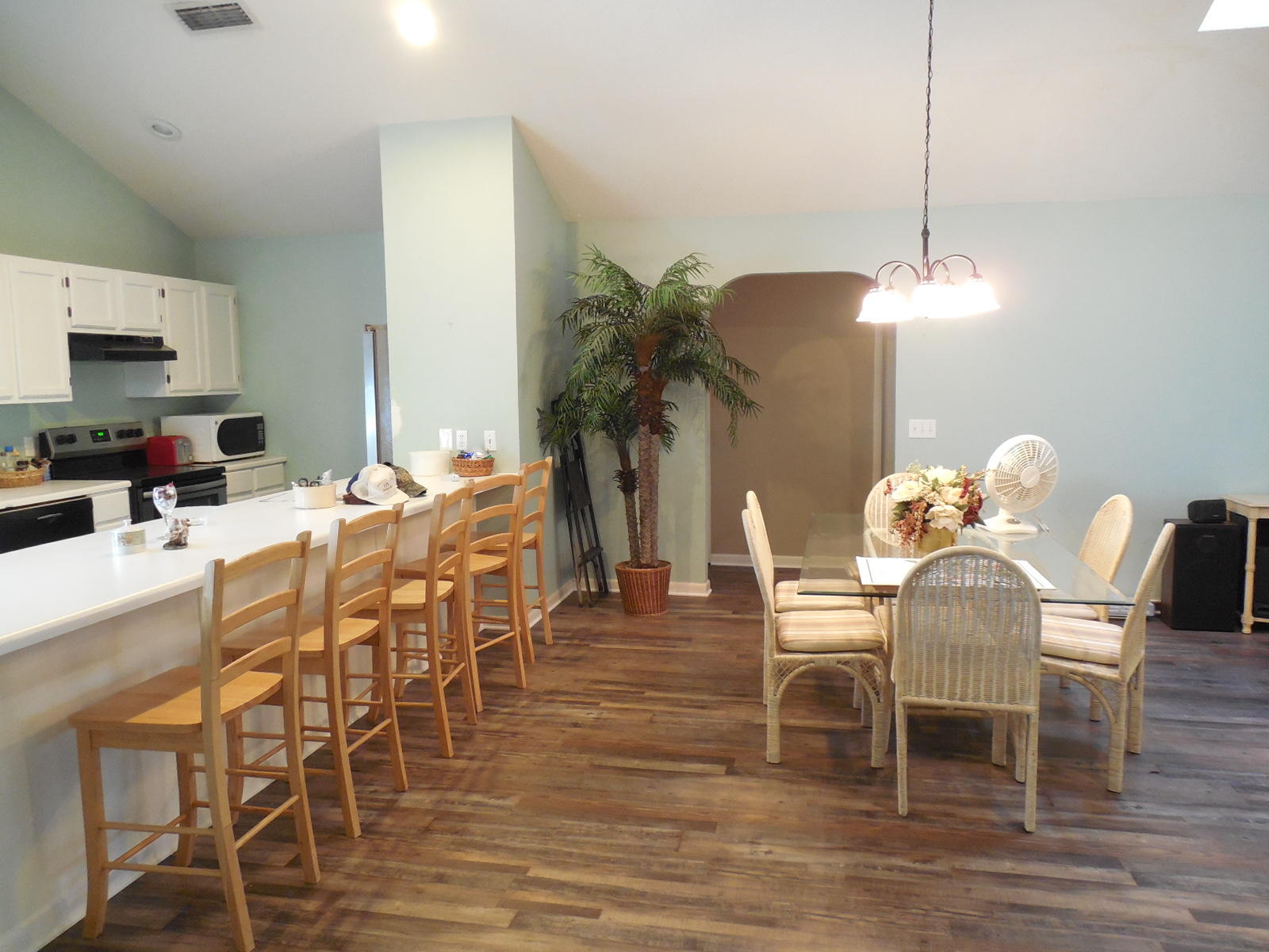 732 Spring Lake Road DeFuniak Springs, FL 32433 - Photo 32 of 44 a dining room with furniture potted plants and wooden floor