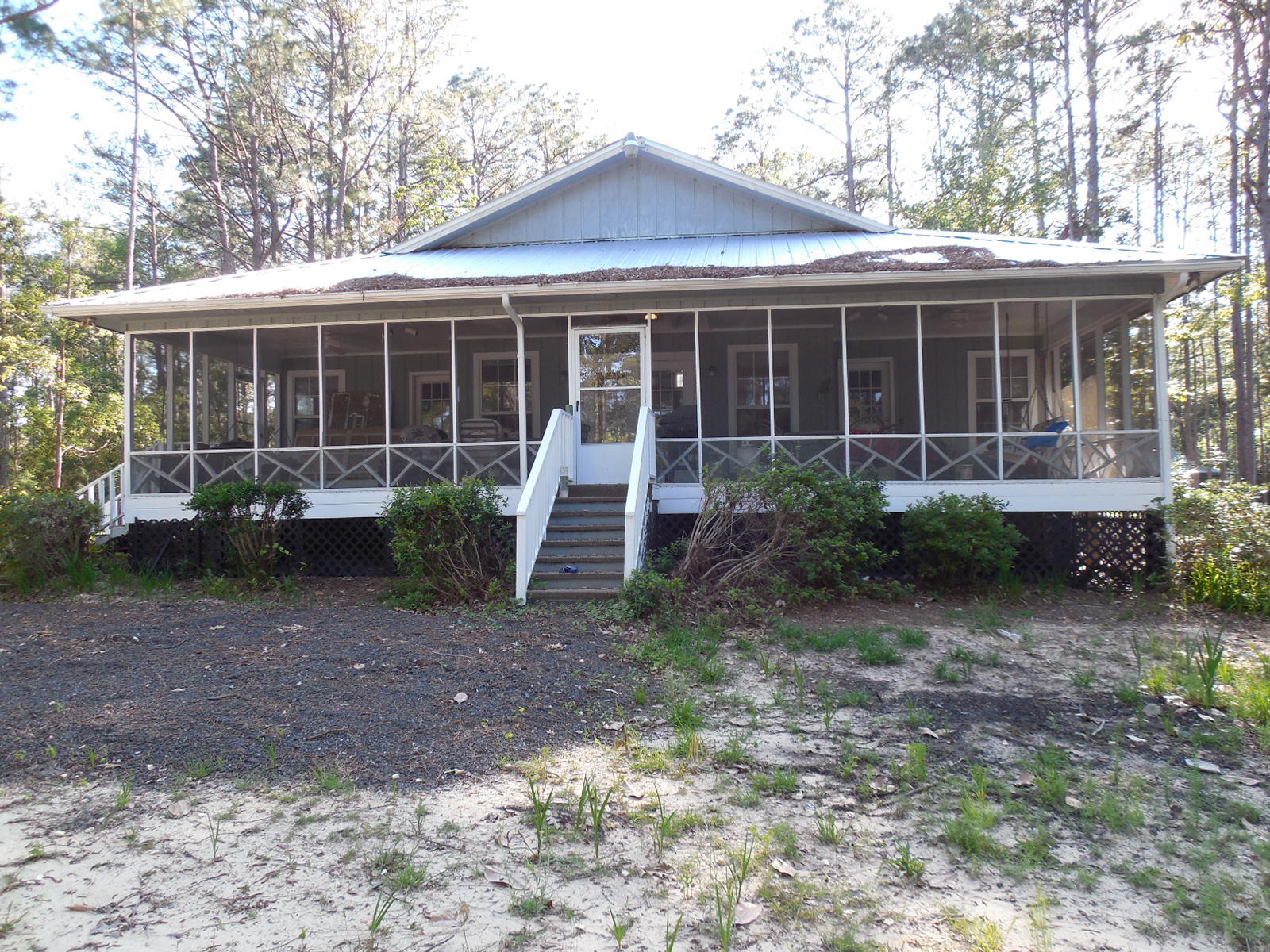 732 Spring Lake Road DeFuniak Springs, FL 32433 - Photo 6 of 44 a front view of a house with garden and plants