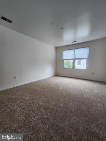 an empty room with a empty space and windows