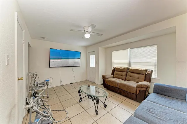 a living room with furniture and a flat screen tv
