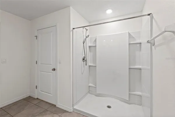 a bathroom that has a glass shower door