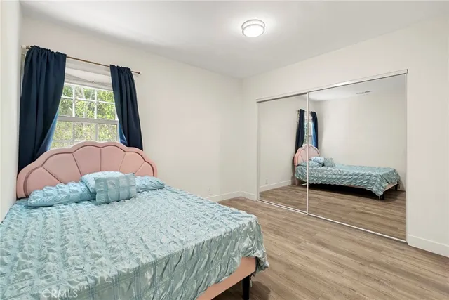 a bedroom with a bed and window