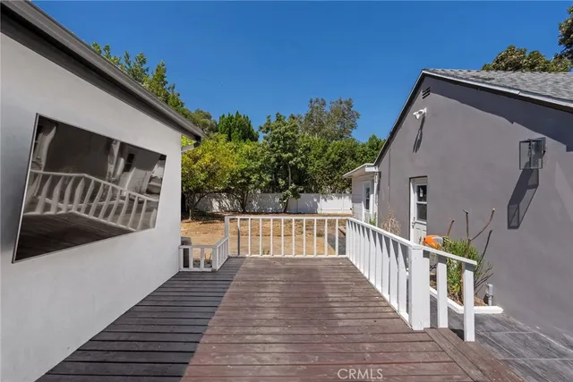 a view of balcony with wooden floor and fence