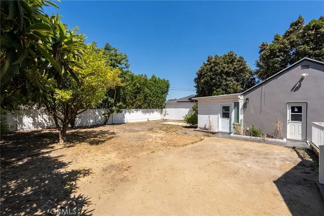 a backyard of a house with large trees