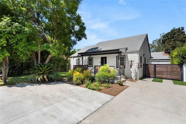 a front view of a house with a garden