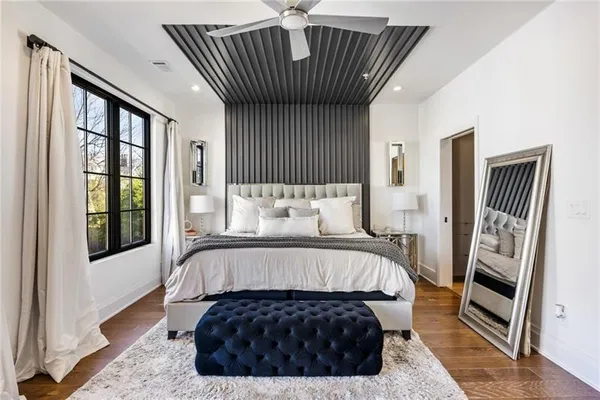 a bedroom with a bed and a large window