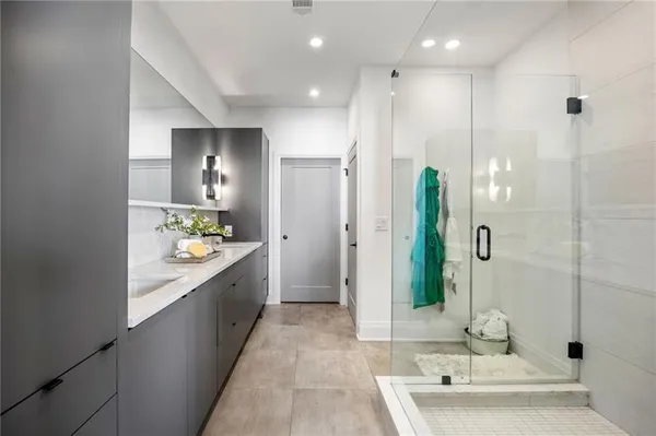a bathroom with a double vanity sink and shower