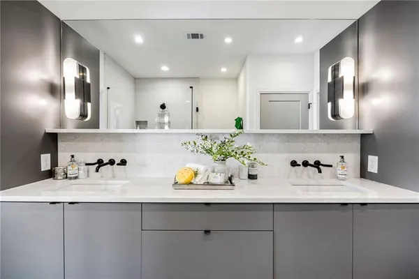 a kitchen with a sink a potted plant and cabinets