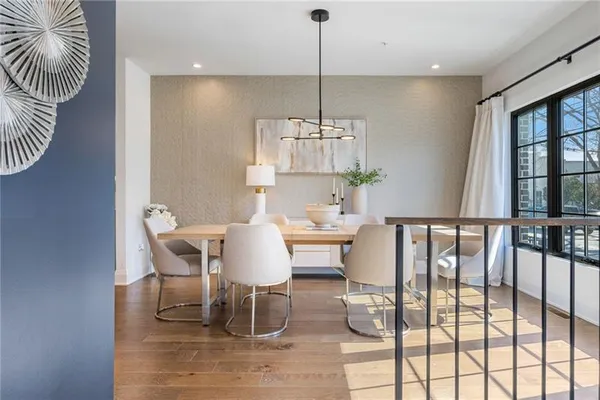 a dining room with furniture a chandelier and window