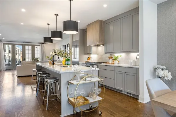 a kitchen with a sink cabinets and wooden floor