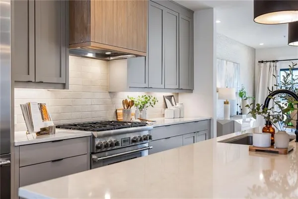 a kitchen with granite countertop a stove and a sink