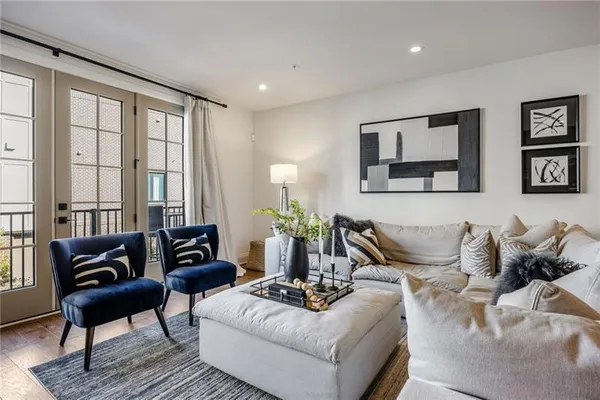 a living room with furniture and large windows