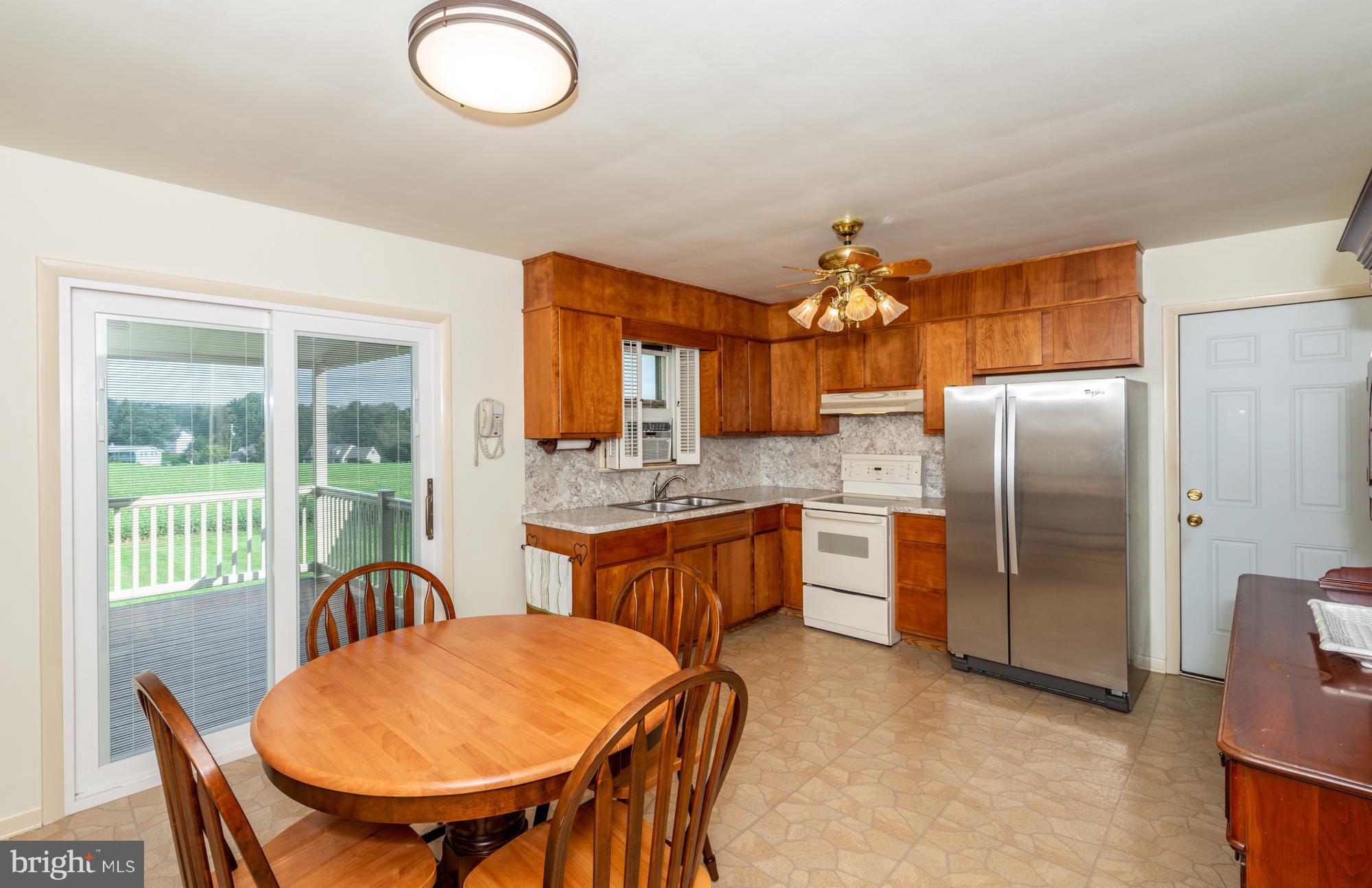 336 School Road Denver, PA 17517 - Photo 12 of 26 a kitchen with stainless steel appliances granite countertop a kitchen island a table and chairs in it