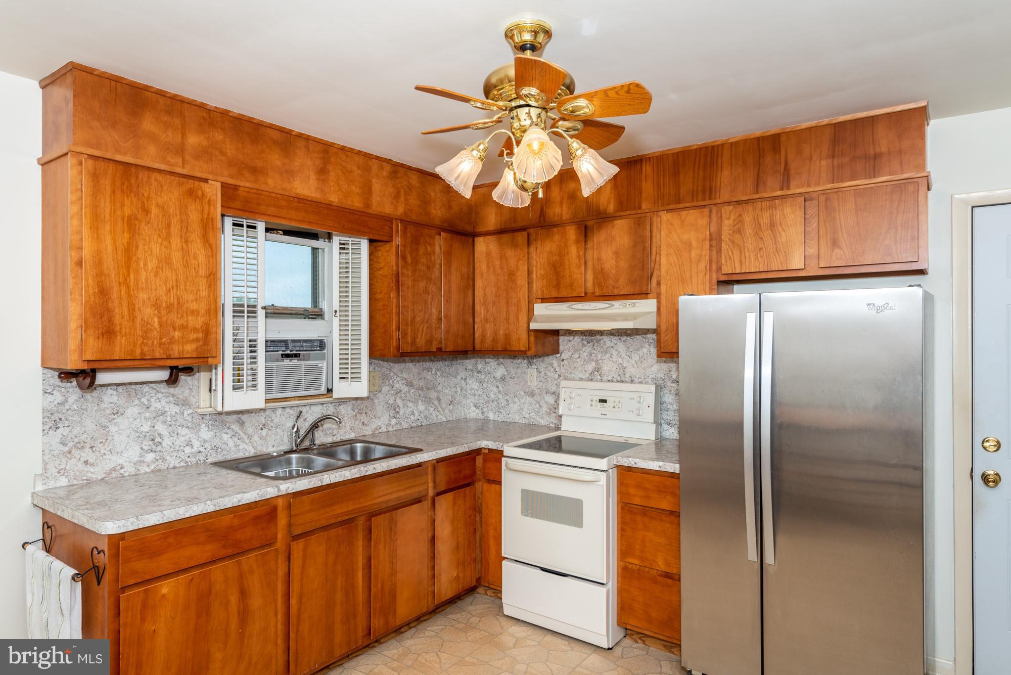 336 School Road Denver, PA 17517 - Photo 13 of 26 a kitchen with stainless steel appliances a sink cabinets and a refrigerator