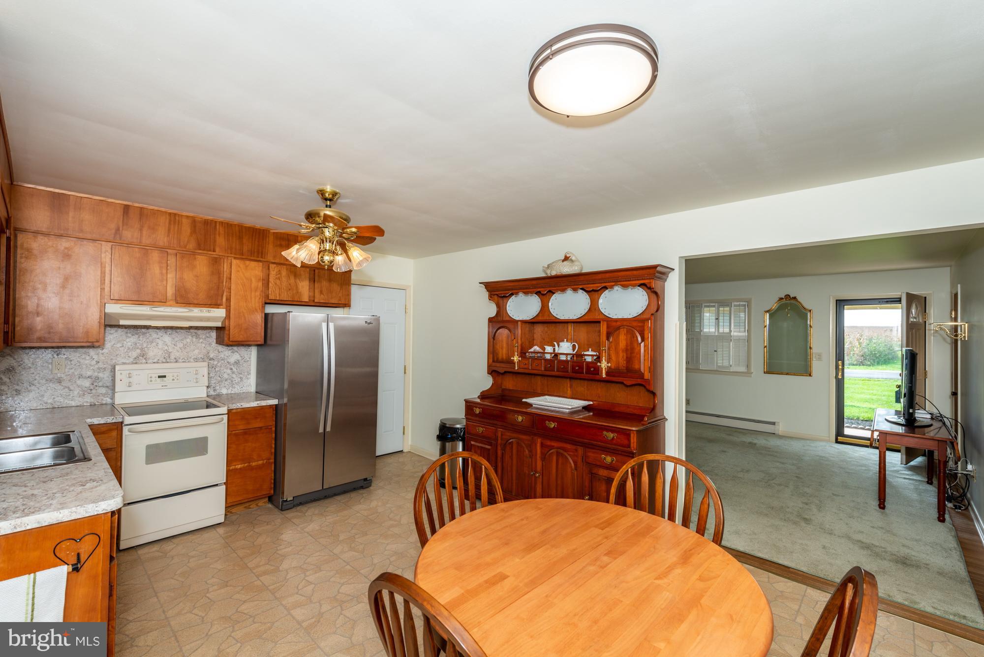 336 School Road Denver, PA 17517 - Photo 10 of 26 a living room with stainless steel appliances furniture a chandelier and a kitchen view