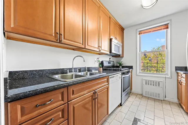 a kitchen with stainless steel appliances granite countertop a sink and cabinets