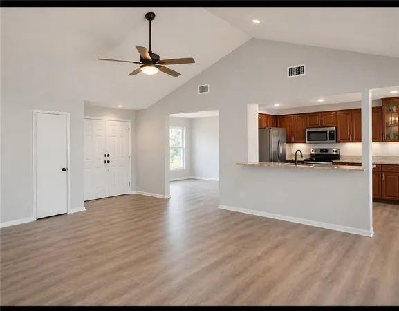 a view of a kitchen with a sink and a window