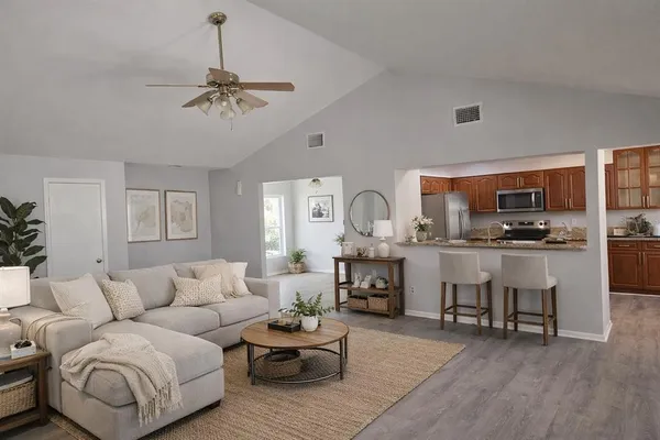 a living room with furniture and kitchen view