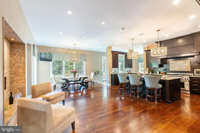 a living room with lots of furniture and kitchen view
