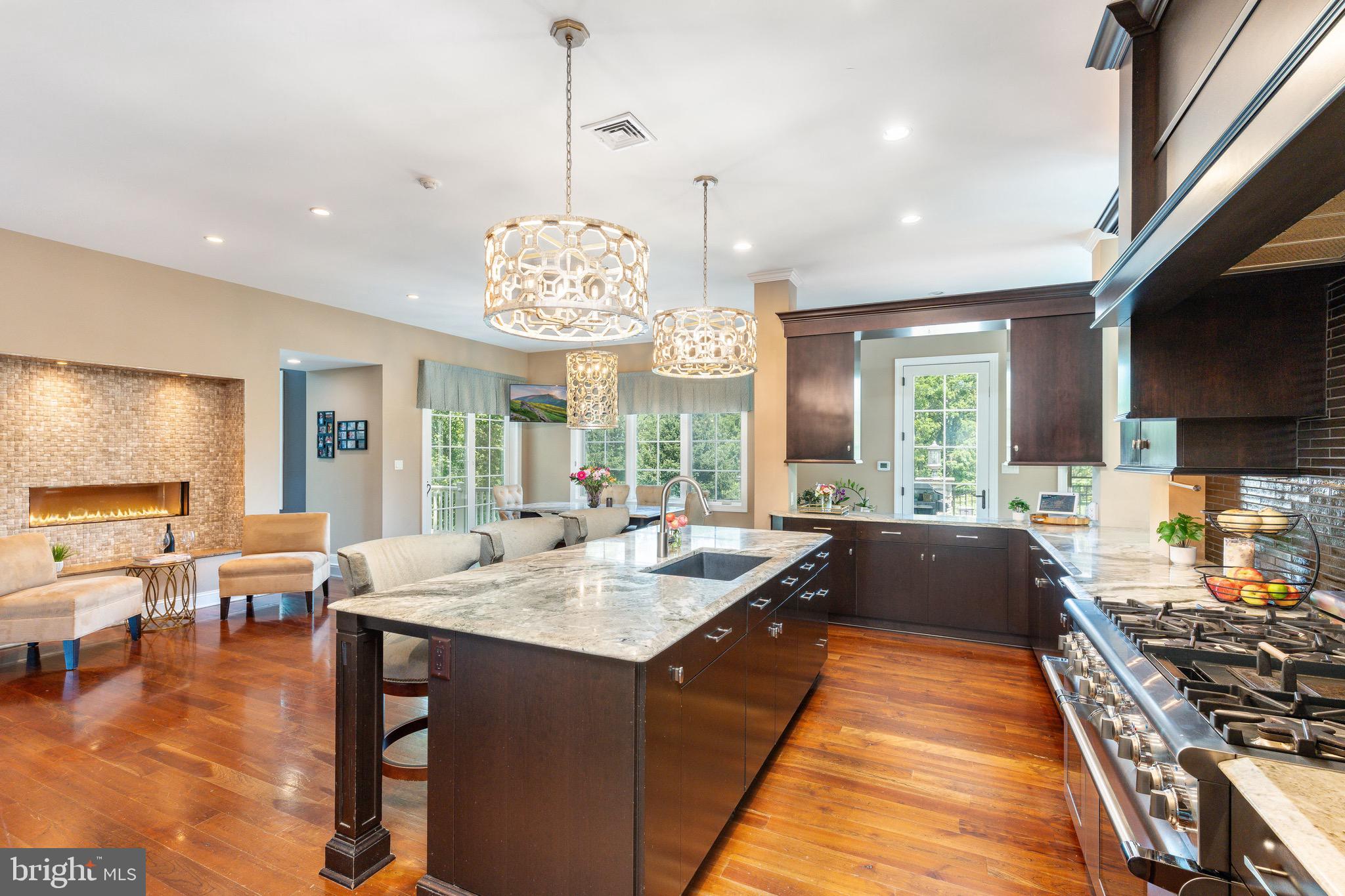 3 Stonebridge Crossing Road Newtown, PA 18940 - Photo 13 of 77 a large dining hall with stainless steel appliances granite countertop a stove and a view of dining hall with couches