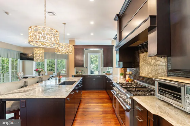 a large kitchen with stainless steel appliances granite countertop a lot of counter space