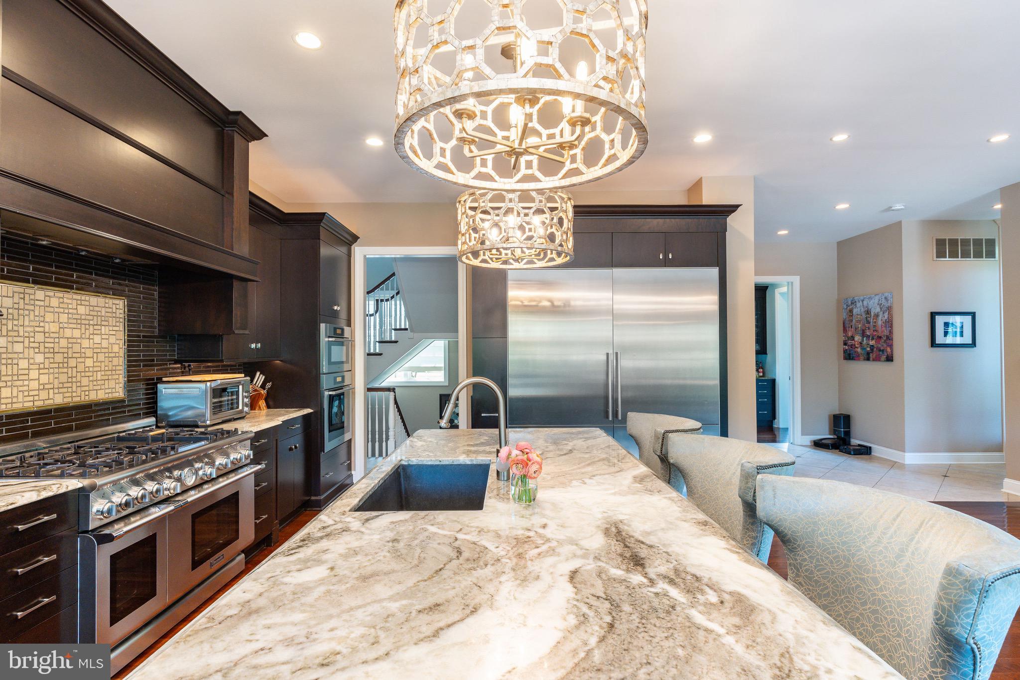 3 Stonebridge Crossing Road Newtown, PA 18940 - Photo 15 of 77 a kitchen with stainless steel appliances kitchen island granite countertop a stove a sink and a refrigerator