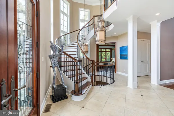 a view of entryway with wooden floor and windows