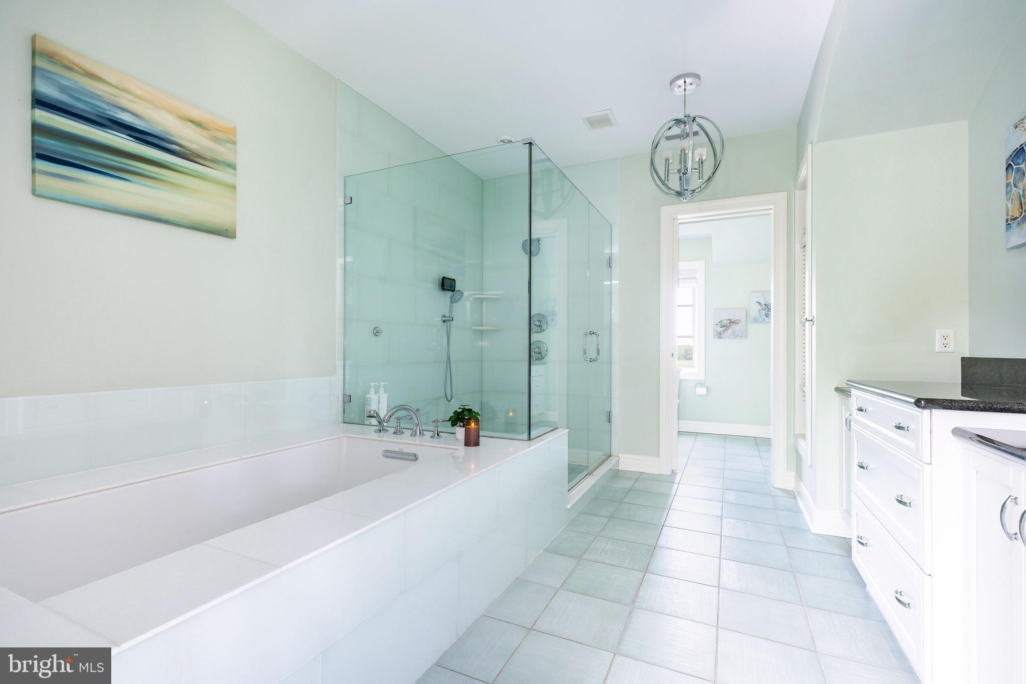 3 Stonebridge Crossing Road Newtown, PA 18940 - Photo 31 of 77 a spacious bathroom with a tub a sink and a large mirror